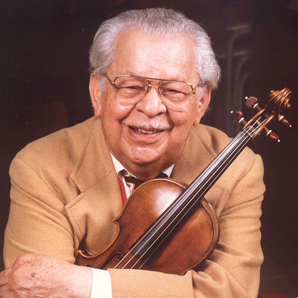 Photo of a man holding a violin